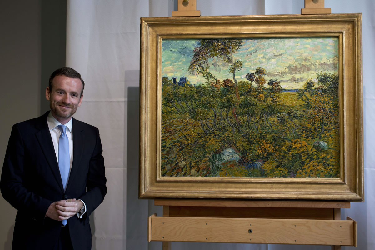 Van Gogh Museum director Axel Rueger, left, looks at &quot;Sunset at Montmajour&quot; after unveiling the painting by Dutch painter Vincent van Gogh during a press conference at the museum in Amsterdam, Netherlands, on Monday. The museum has identified the long-lost painting which was painted by the Dutch mater in 1888, the discovery is the first full size canvas that has been found since 1928 and will be on display from Sept.