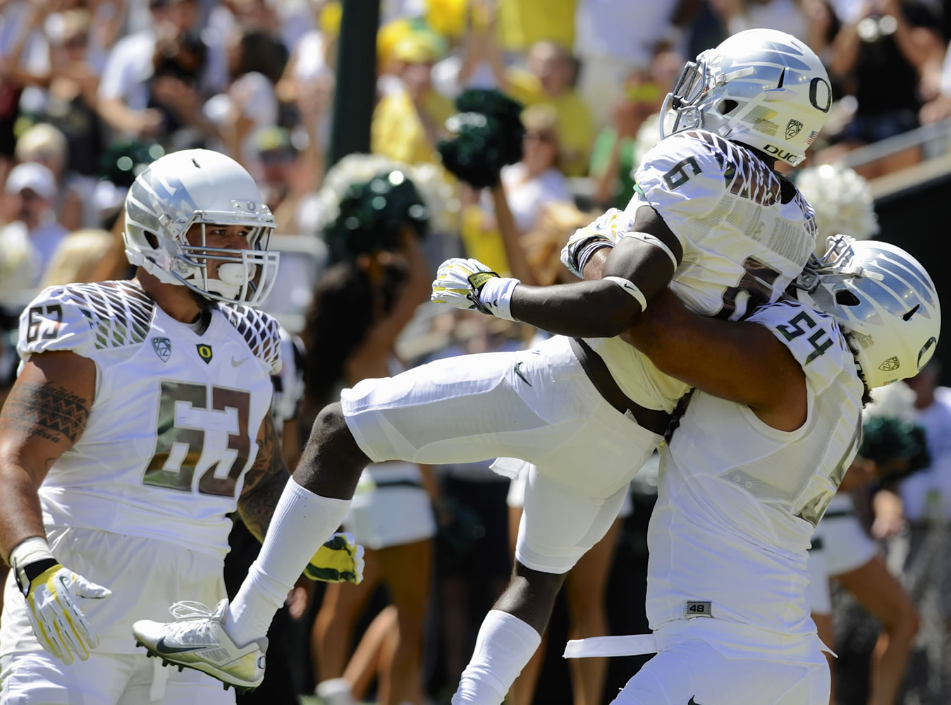 Oregon's De'Anthony Thomas (6) celebrates his touchdown with teammates Hamani Stevens (54) and Mana Craig (63) against Nicholls during the first half Saturday.