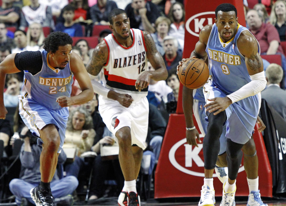 Denver Nuggets' Andre Iguodala (9) and Andre Miller (24) race downcourt on a fast break as Portland Trail Blazers forward LaMarcus Aldridge (12) follows during the first half of their preseason NBA basketball game in Wednesday in Portland.