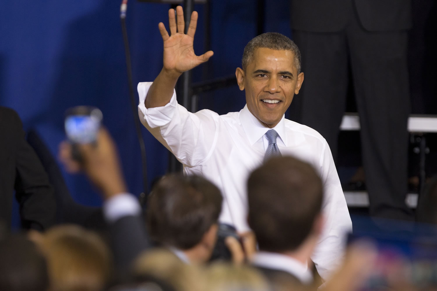 President Barack Obama waves as he arrives to speak about the Affordable Care Act on Thursday at Prince George's Community College in Largo, Md.