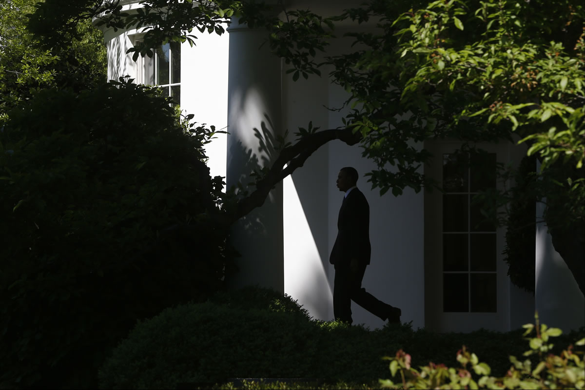 President Barack Obama whistles as he walks from the Oval Office to the South Lawn of the White House in Washington on Thursday before boarding the Marine One helicopter to begin his trip to Mexico and Costa Rica.