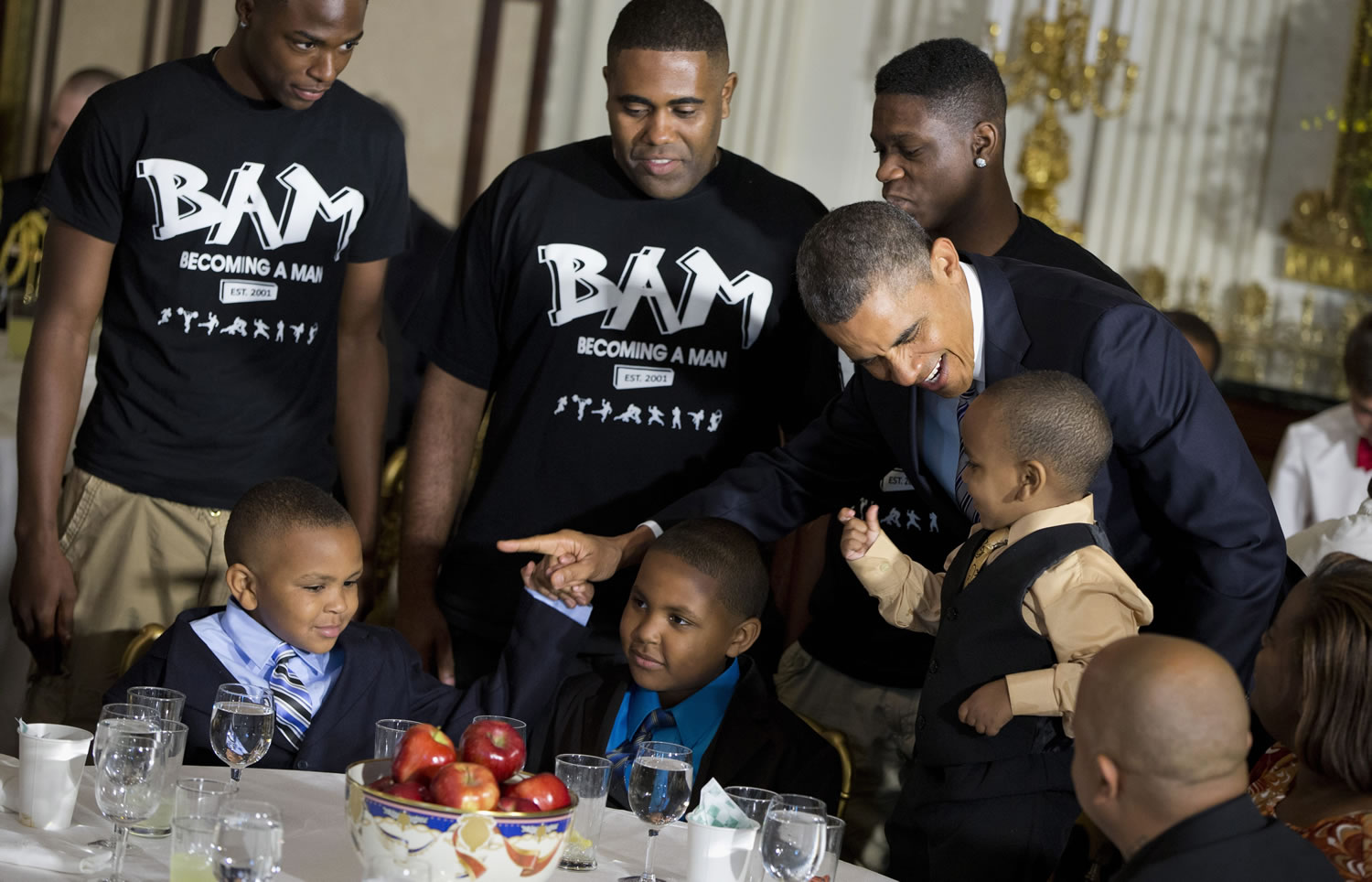 President Barack Obama greets guests, including fathers and their children participants in the Becoming a Man (BAM) program at Hyde Park Academy in Chicago, on Friday  in the State Dining Room of the White House in Washington, where the president hosted a Father's Day luncheon.