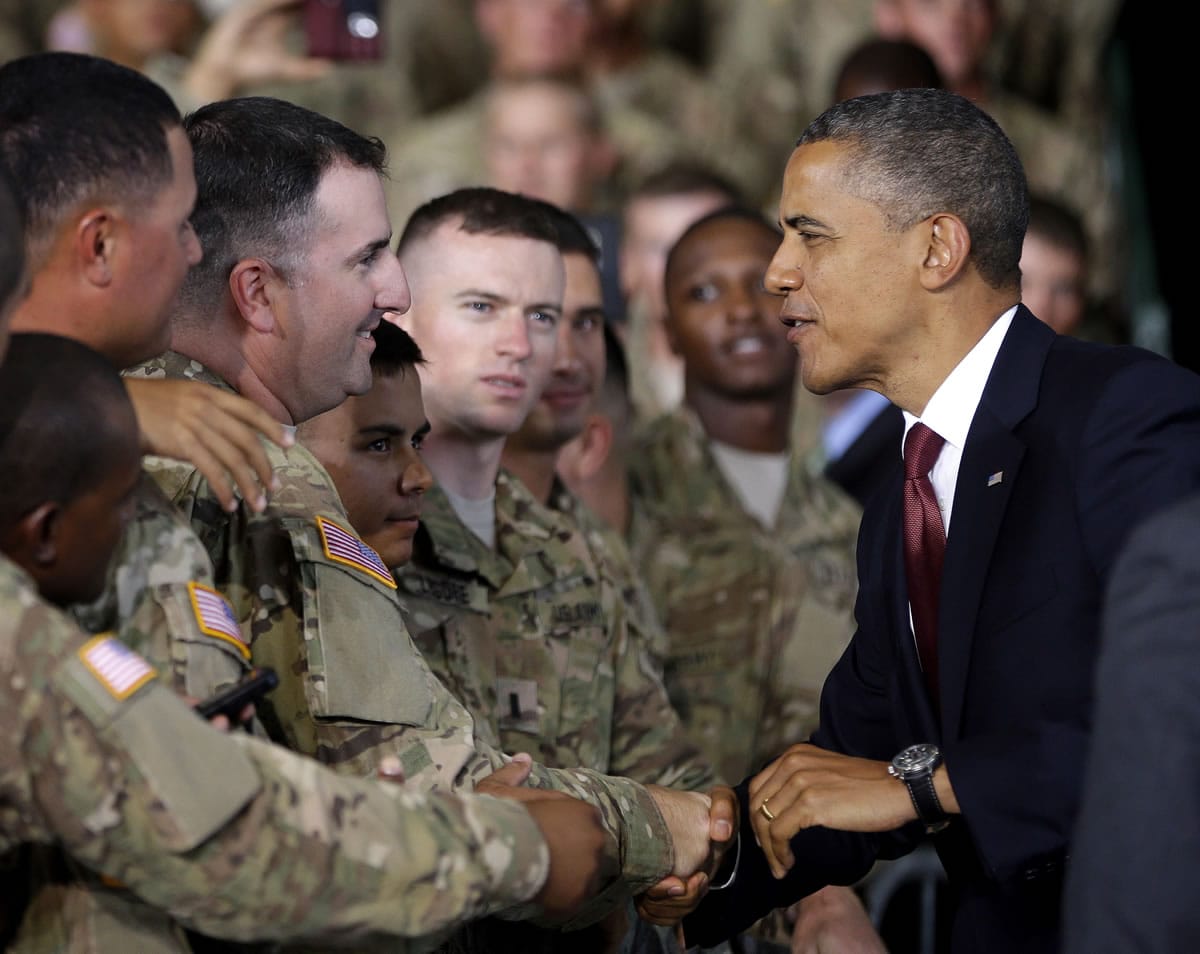 President Barack Obama, right, greets members of the military before speaking at Fort Bliss, Texas, Friday, Aug. 31, 2012.