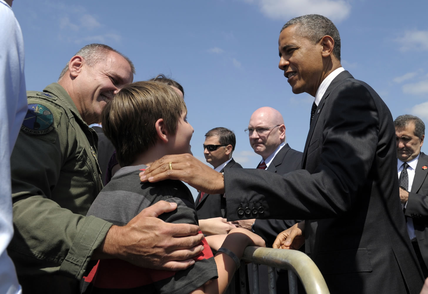 President Barack Obama talks to Vancouver residents Thomas Bieniewicz, 10, and his father, Col. Mike Bieniewicz, left, after arriving at the Oregon Air National Guard Base in Portland on Tuesday.