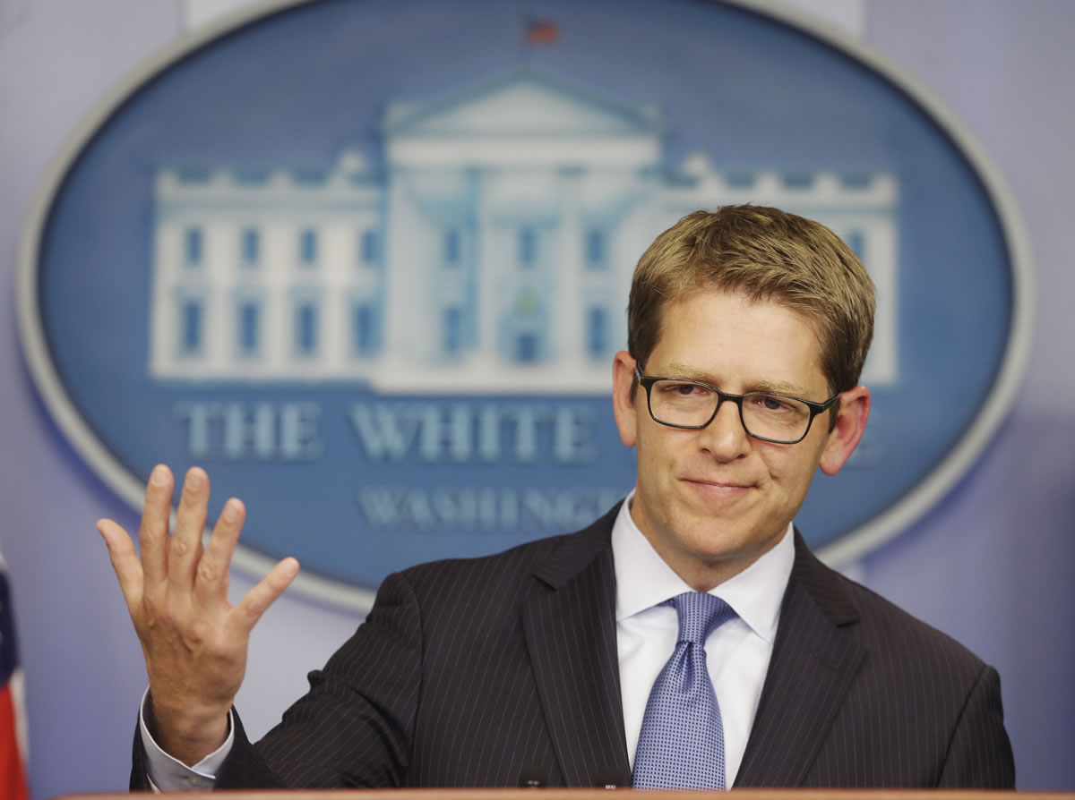 White House press secretary Jay Carney throws his hands up when asked about President Barack Obama's plans for the following week during his daily news briefing at the White House in Washington on Friday.