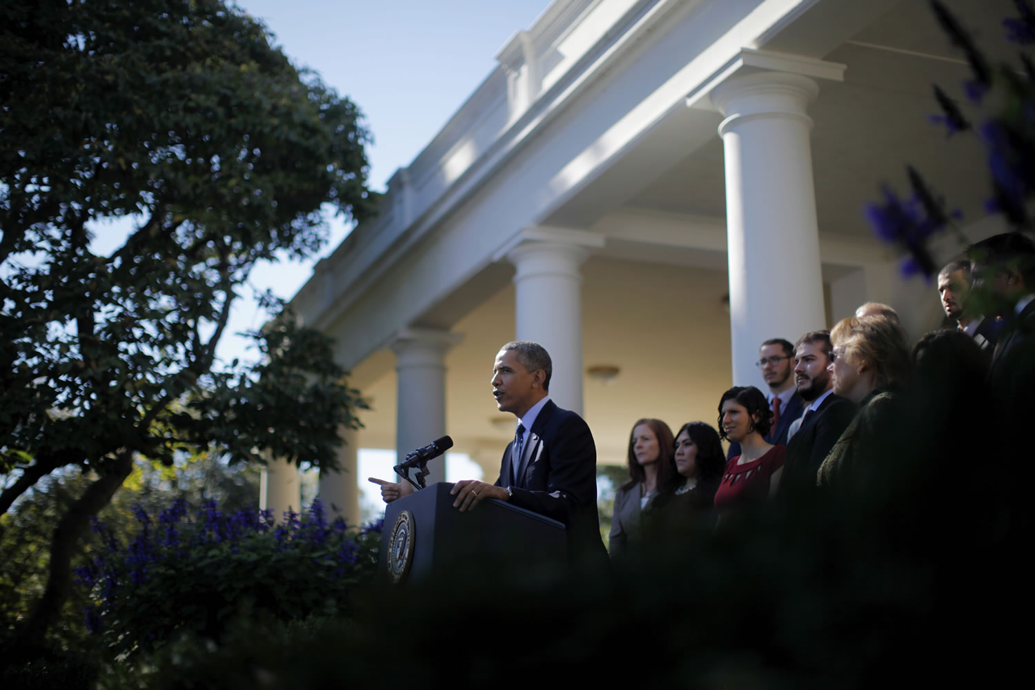 President Barack Obama, standing with supporters of his health care law, speaks in the Rose Garden of the White House in Washington on Monday on the initial rollout of the health care overhaul.