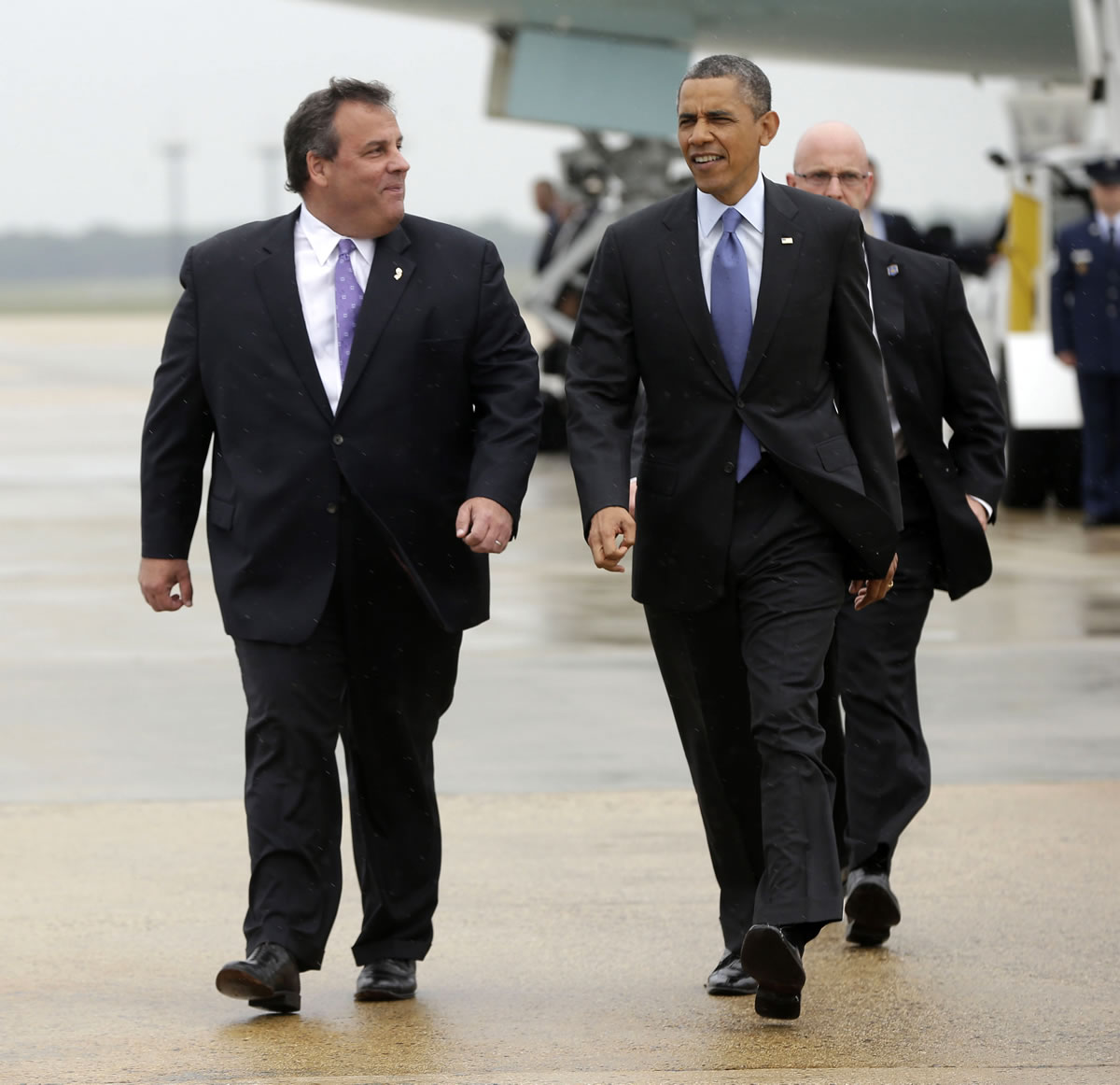 President Barack Obama walks on the tarmac with Gov.