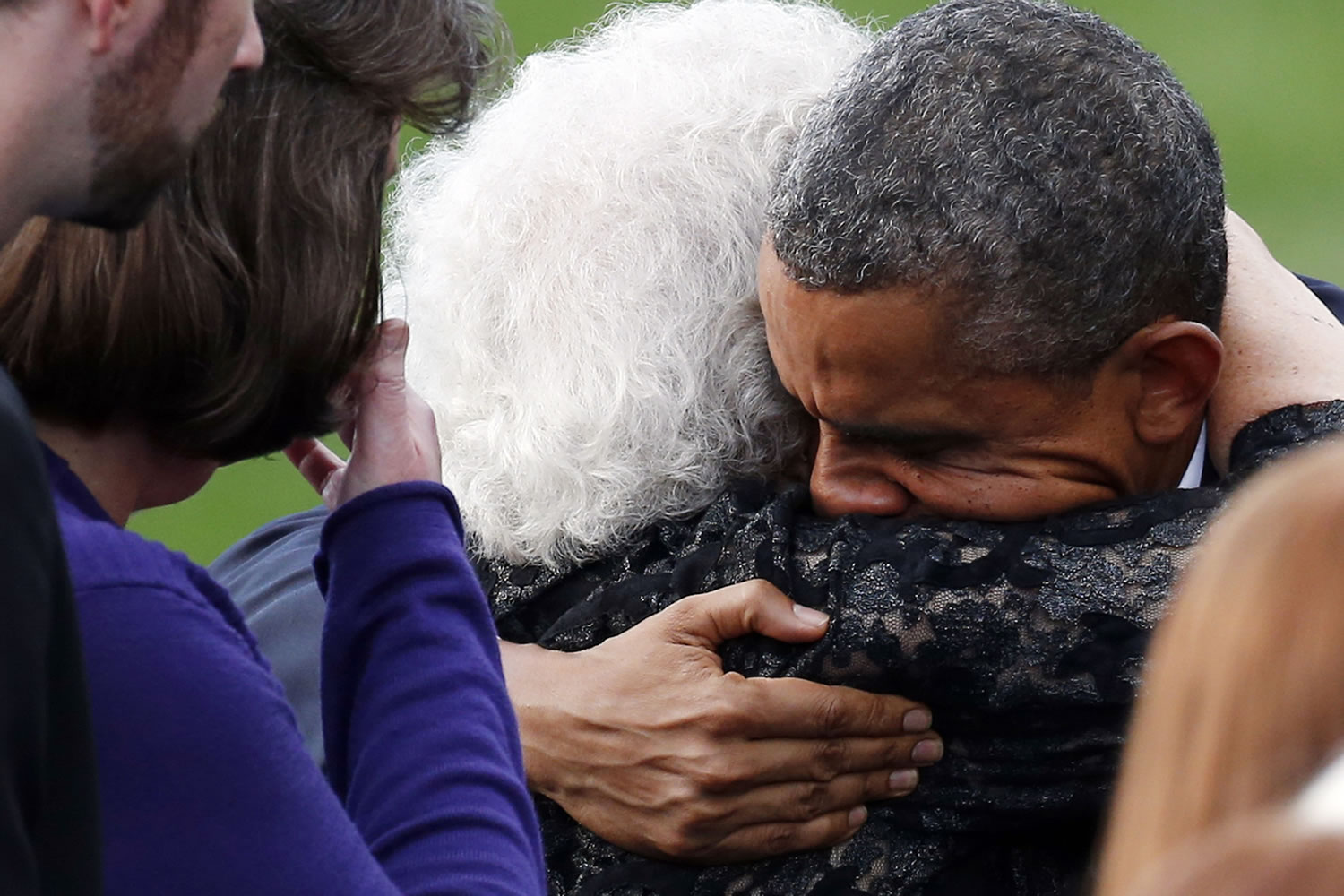 President Barack Obama hugs a family member Sunday during a memorial service at Marine Barracks Washington, D.C., for the victims of the Washington Navy Yard shooting.