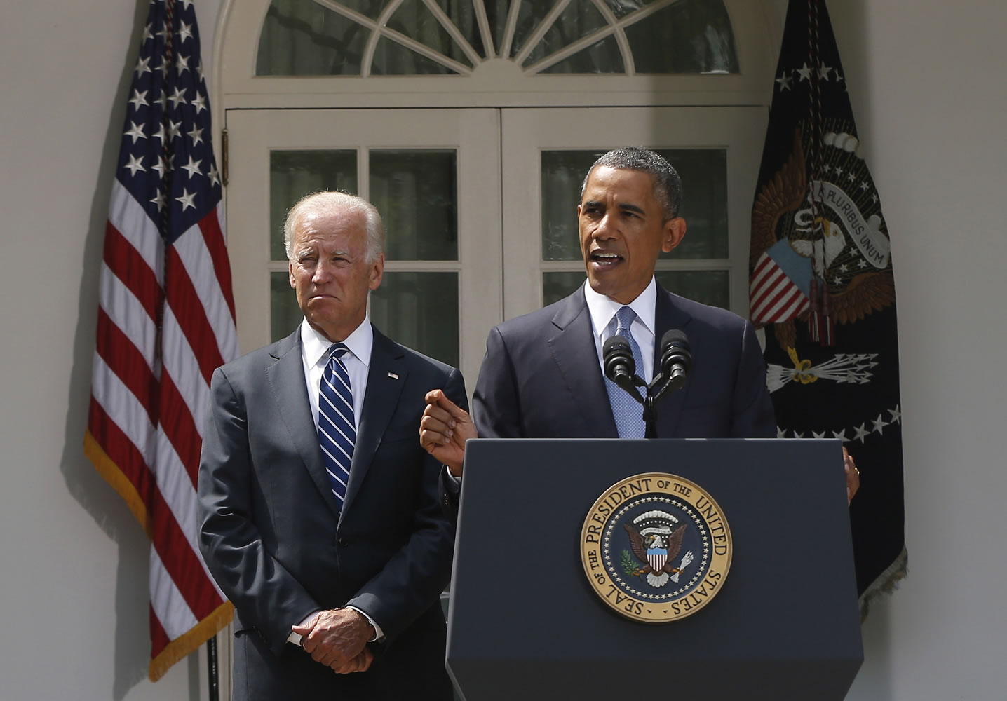 President Barack Obama stands with Vice President Joe Biden on Saturday as he makes a statement about the crisis in Syria in the Rose Garden at the White House in Washington.
