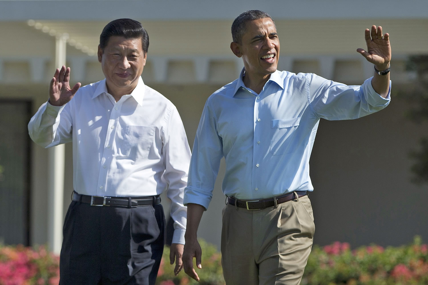 President Barack Obama and Chinese President Xi Jinping, left, walk at the Annenberg Retreat on the Sunnylands estate Saturday in Rancho Mirage, Calif. While saying it is critical that the U.S.