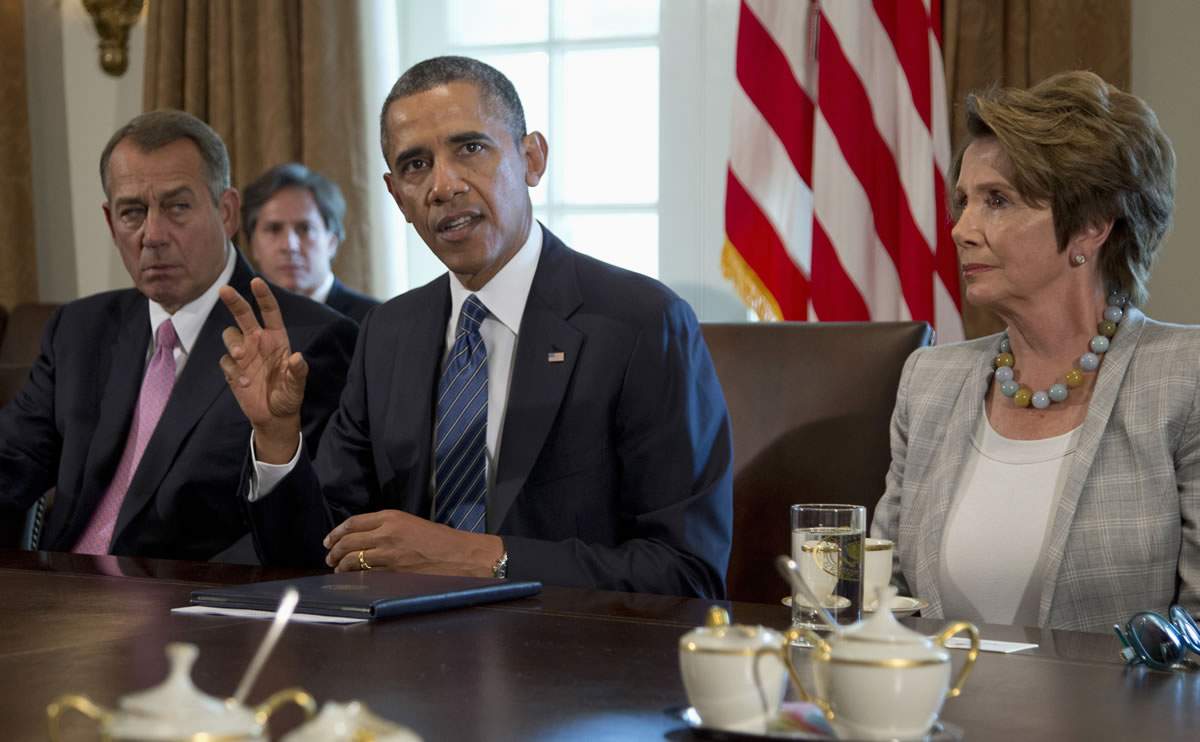 President Barack Obama, flanked by House Speaker John Boehner of Ohio, left, and House Minority Leader Nancy Pelosi of Calif.,  speaks to media in the Cabinet Room of the White House in Washington on Tuesday before a meeting with members of Congress to discuss the situation in Syria.