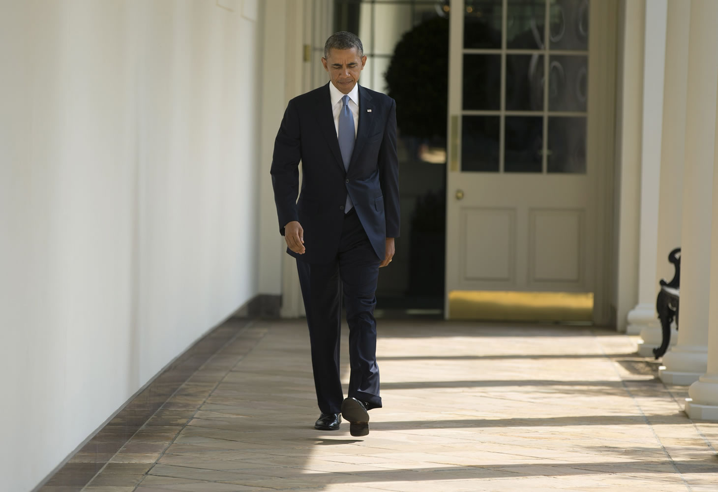 President Barack Obama walks along the West Wing Colonnade towards the Oval Office of the White House in Washington on Tuesday ahead of his daily briefing.