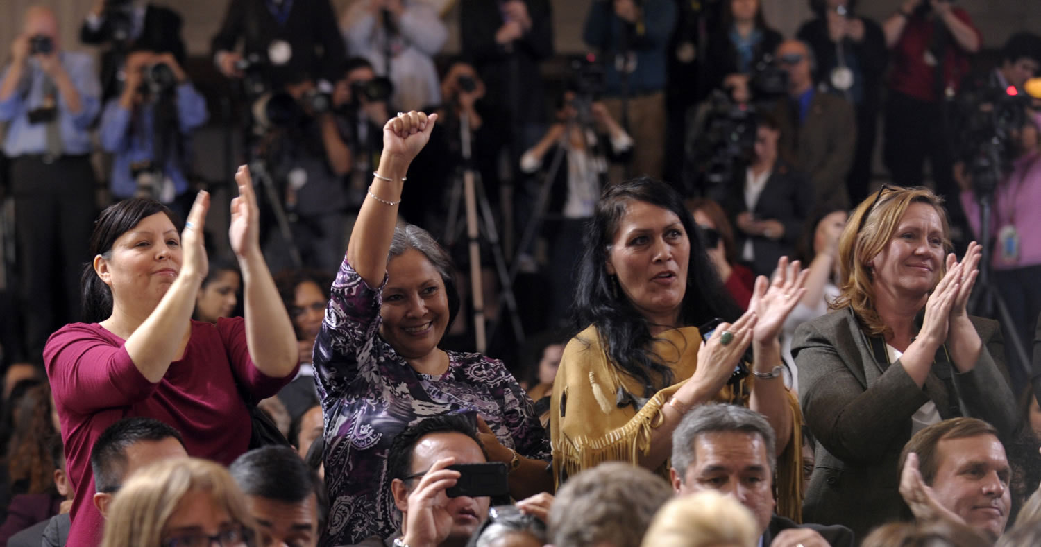 The audience reacts to remarks by President Barack Obama on Thursday at the Interior Department in Washington before the president signed the Violence Against Women Act.