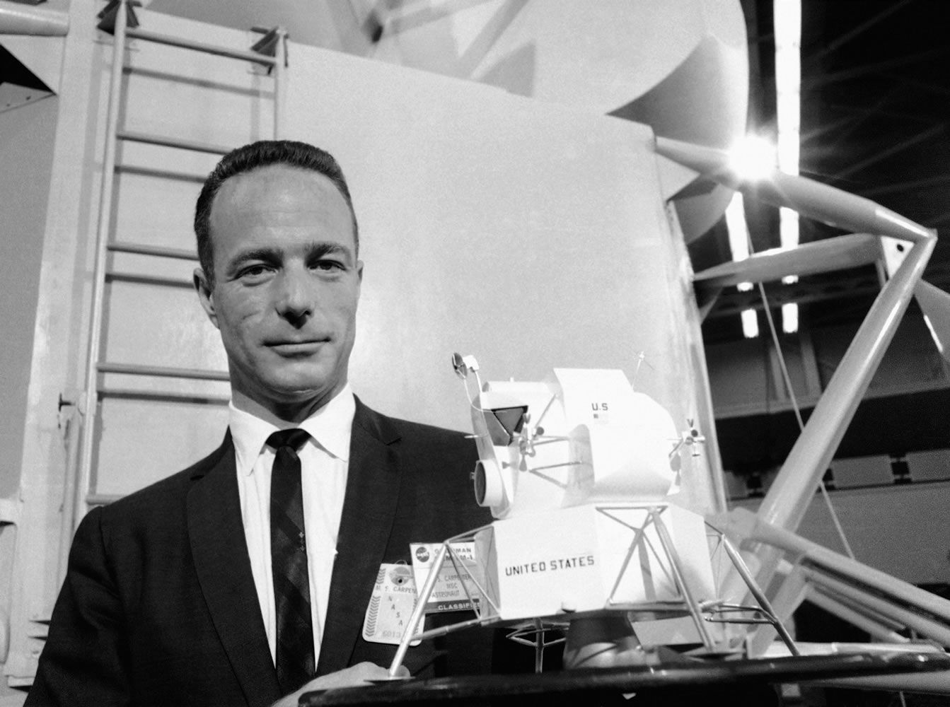 In this March 26, 1967 file photo, astronaut Scott Carpenter poses with model of the Lunar Excursion Module (LEM) at Grumman Aircraft engineering Corp. plant in Bethpage, N.Y. Carpenter, the second American to orbit the Earth and first person to explore both the heights of space and depths of the ocean, died Thursday, Oct. 10, 2013 after a stroke.