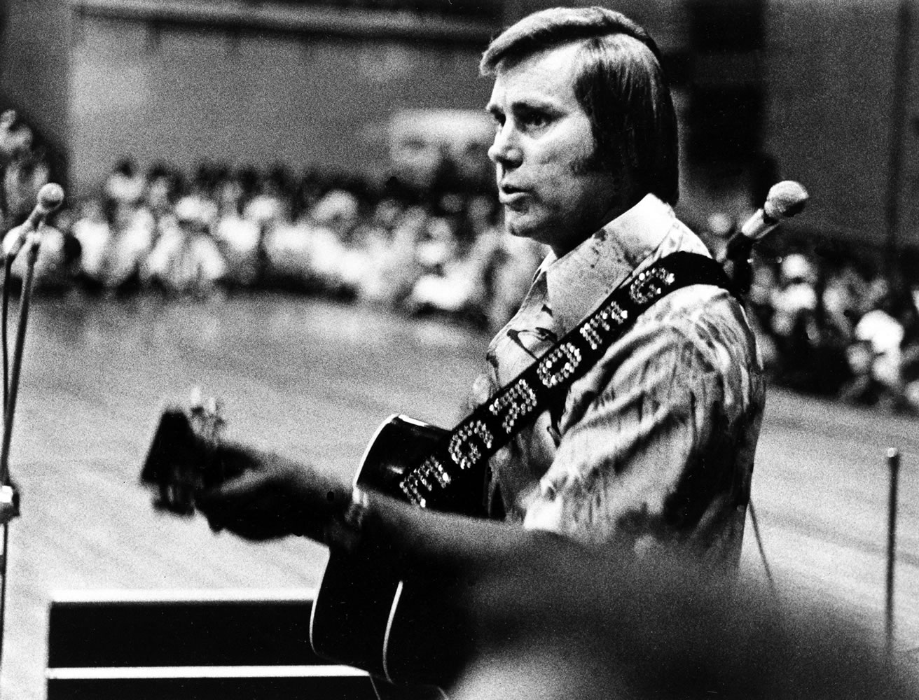 In this undated photo, Country singer George Jones is shown performing with his guitar. Jones, the peerless, hard-living country singer who recorded dozens of hits about good times and regrets and peaked with the heartbreaking classic &quot;He Stopped Loving Her Today,&quot; has died. He was 81.