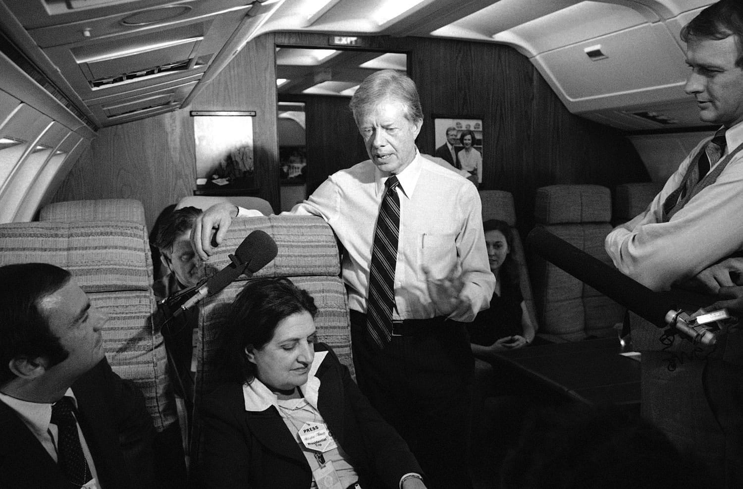 President Jimmy Carter and press secretary Jody Powell, right, talk with reporters Helen Thomas, center, and Sam Donaldson, left, while aboard Air Force One on Oct. 20, 1979 prior to landing at Andrews Air Force Base, Md. Thomas, a pioneer for women in journalism and an irrepressible White House correspondent, died July 20.