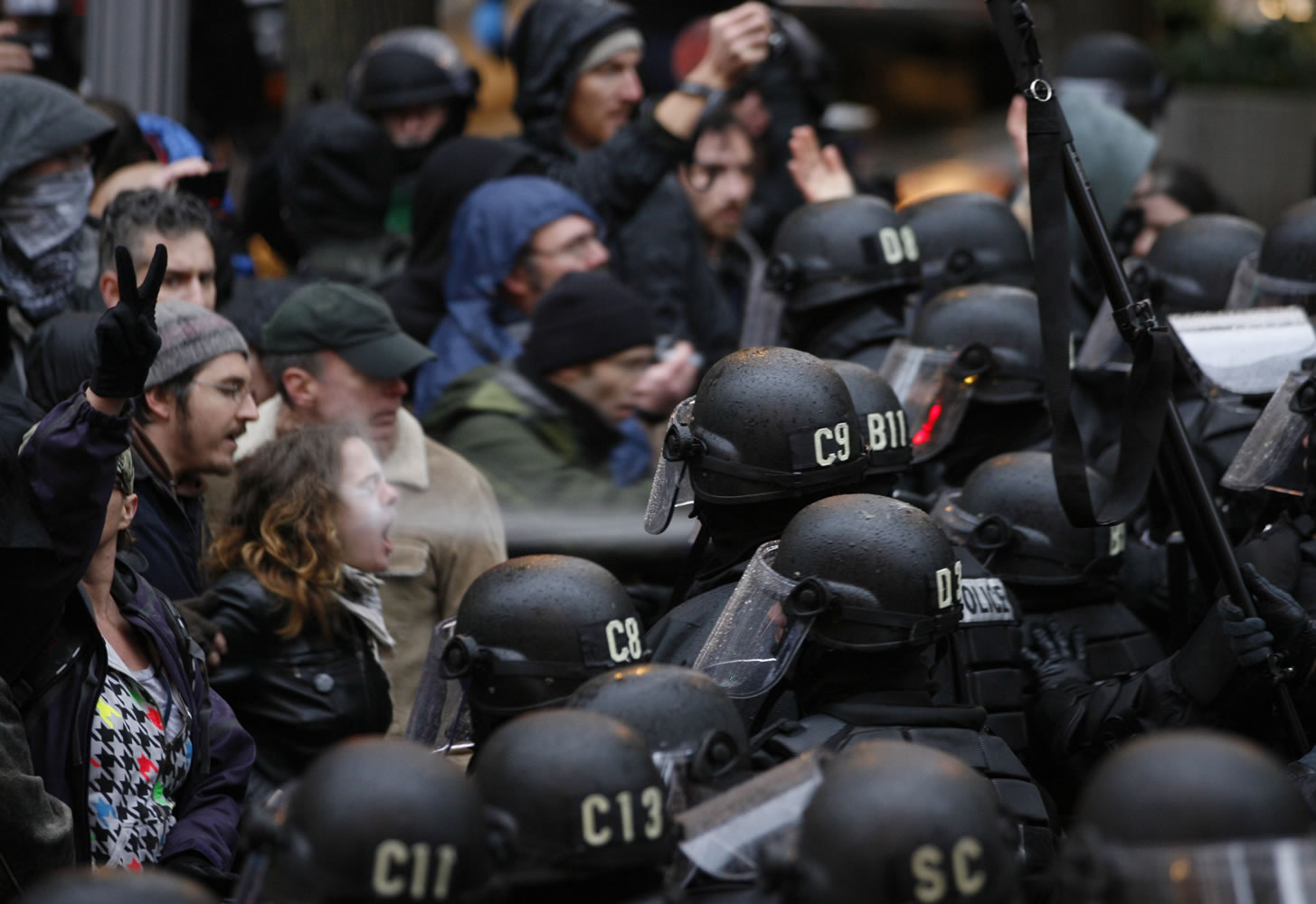 A Portland police officer -- reportedly, Jeffrey McDaniel -- uses pepper spray on Liz Nichols, an Occupy Portland protester, Nov. 17 in Portland.  Nichols' attorneys have filed a $155,000 lawsuit against McDaniel, another officer, and the city.