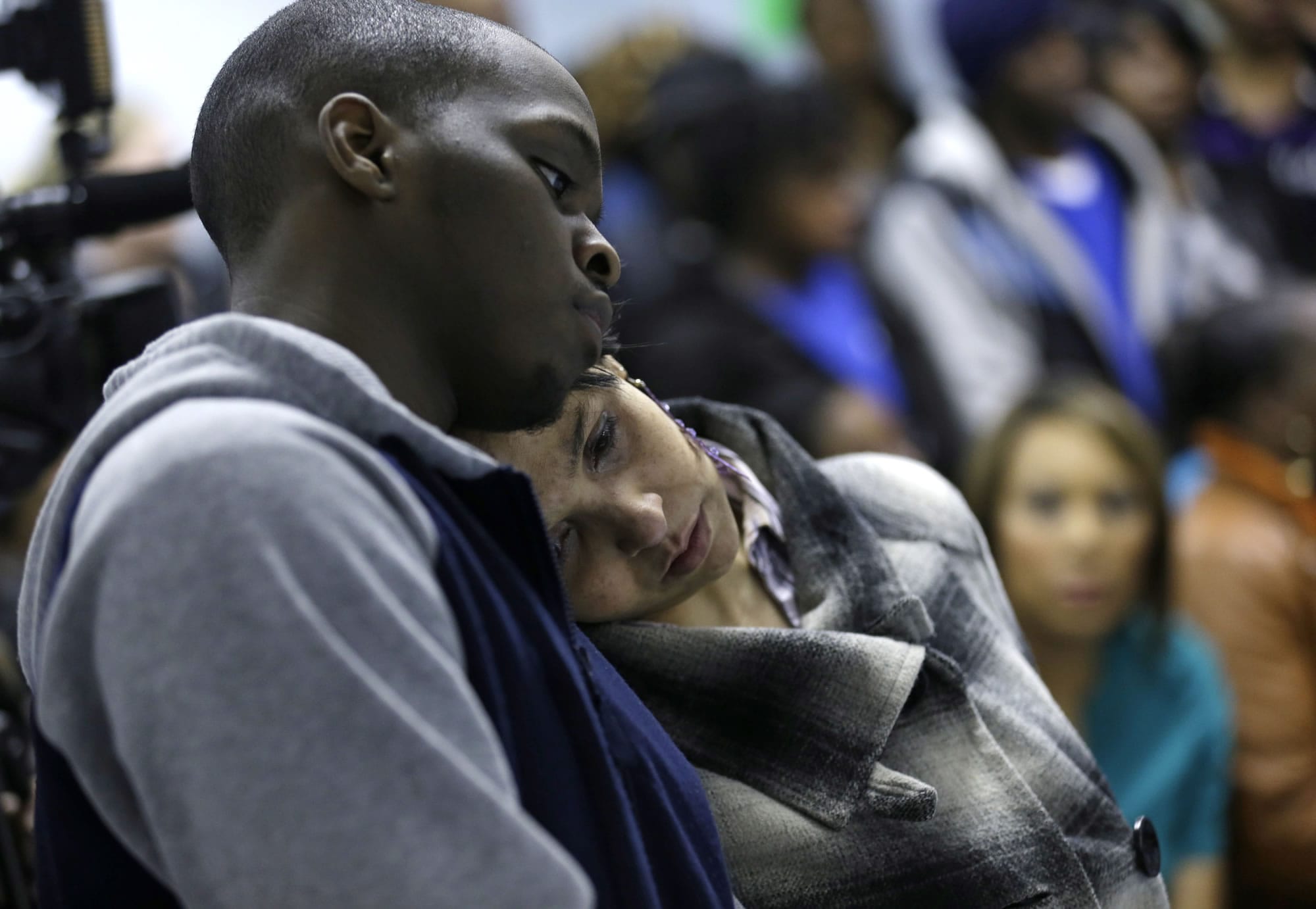 Adrean Bennett, brother of accident victim Andrique Bennett, and Charlene Blackwell hug during a prayer meeting Monday in Warren, Ohio.