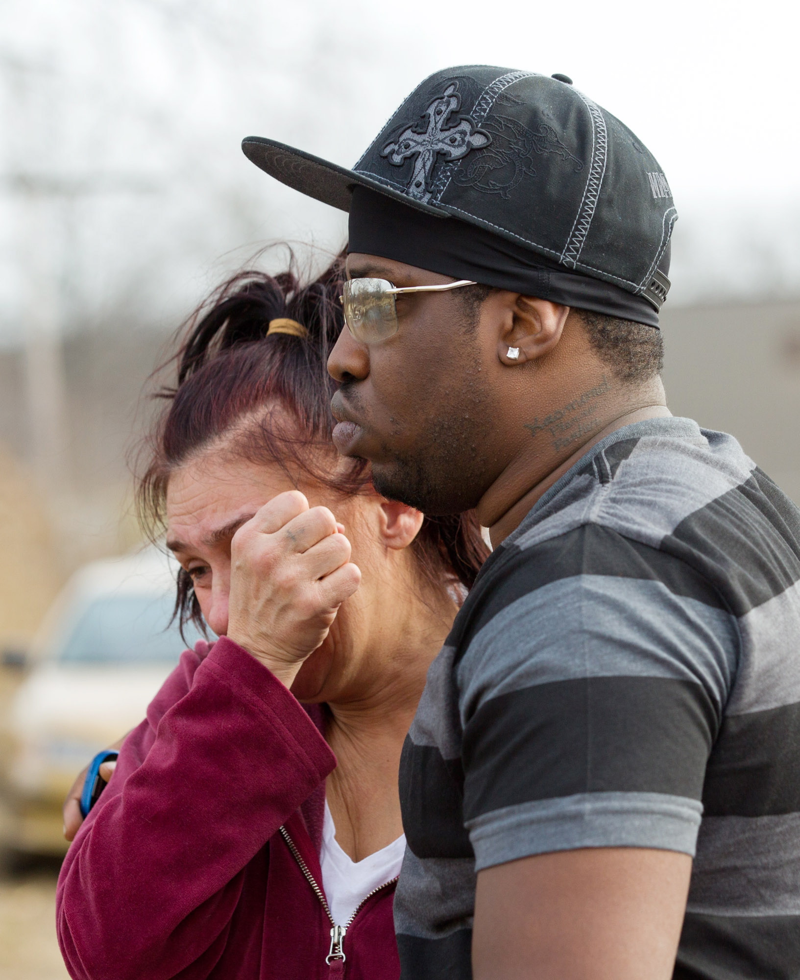 Kasmond Parker, right, consoles Cyndy Mann on Sunday at the crash site in Warren, Ohio.