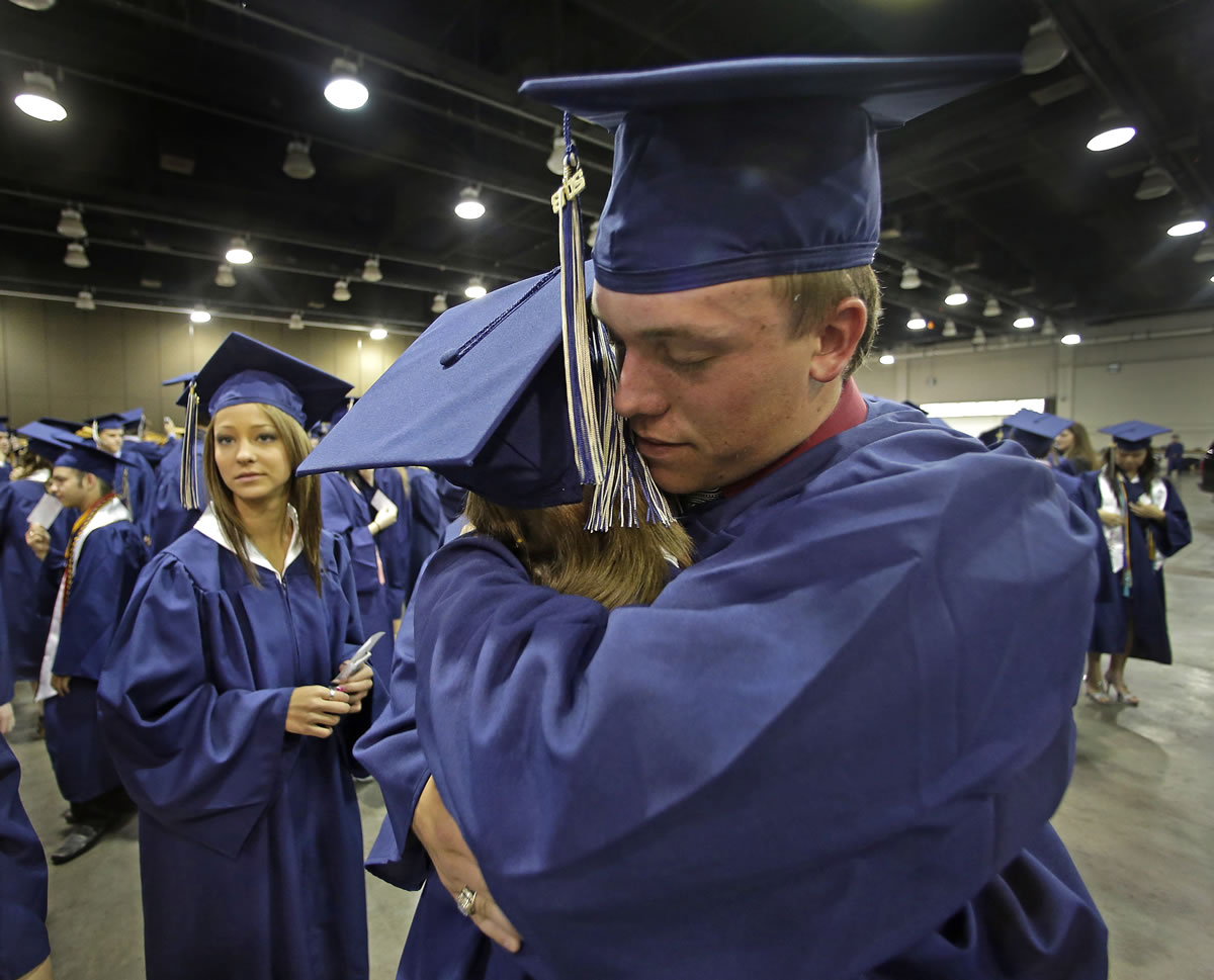 Southmoore High School senior Jake Spradling, hugs a classmate as they get ready to attend their commencement ceremony in Oklahoma City on Saturday, five days after a tornado destroyed a large swath of their attendance area in Moore, Okla.