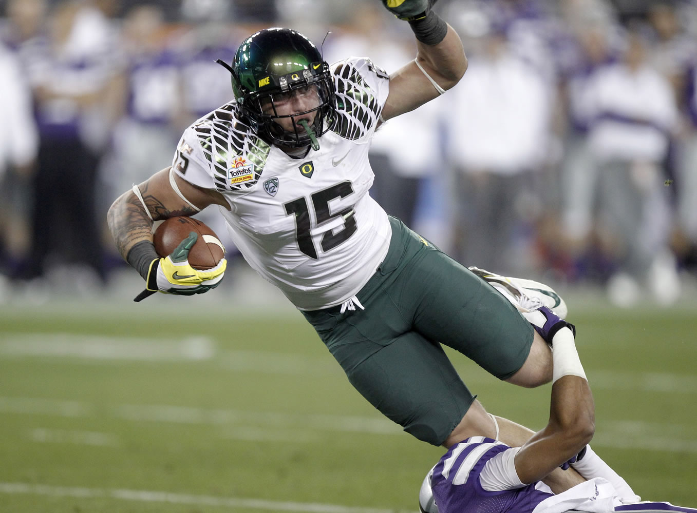 Oregon tight end Colt Lyerla, trying to escape the grasp of Kansas State's Jerard Milo during the Fiesta Bowl in January, left the Ducks program this week.