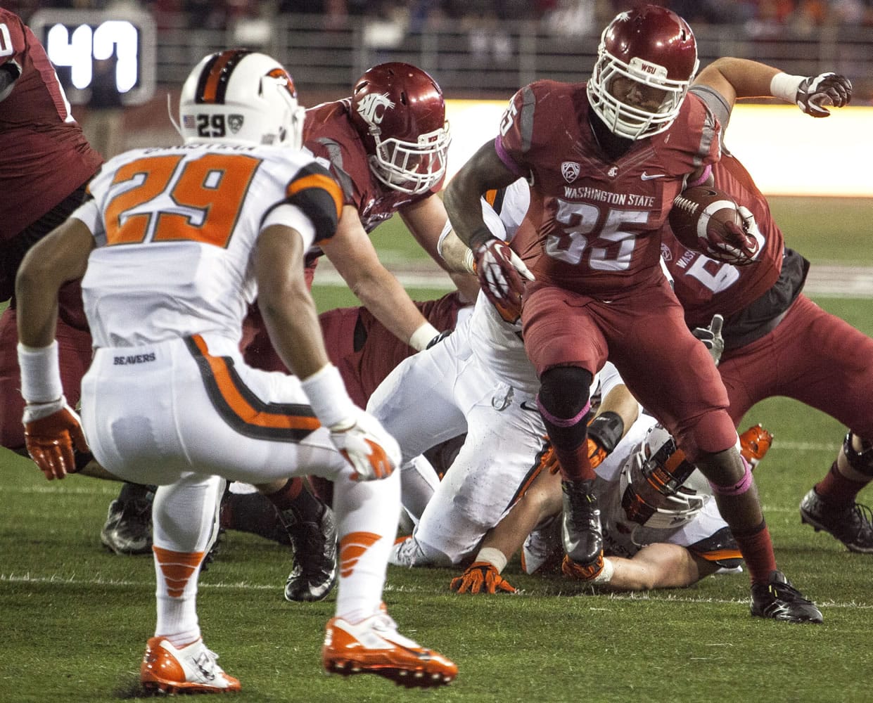 Washington State running back Marcus Mason (35) cuts inside in an effort to avoid safety Steven Christian (29) during the second half of an NCAA college football game Saturday, Oct. 12, 2013, at Martin Stadium in Pullman, Wash. Oregon State won 52-24.