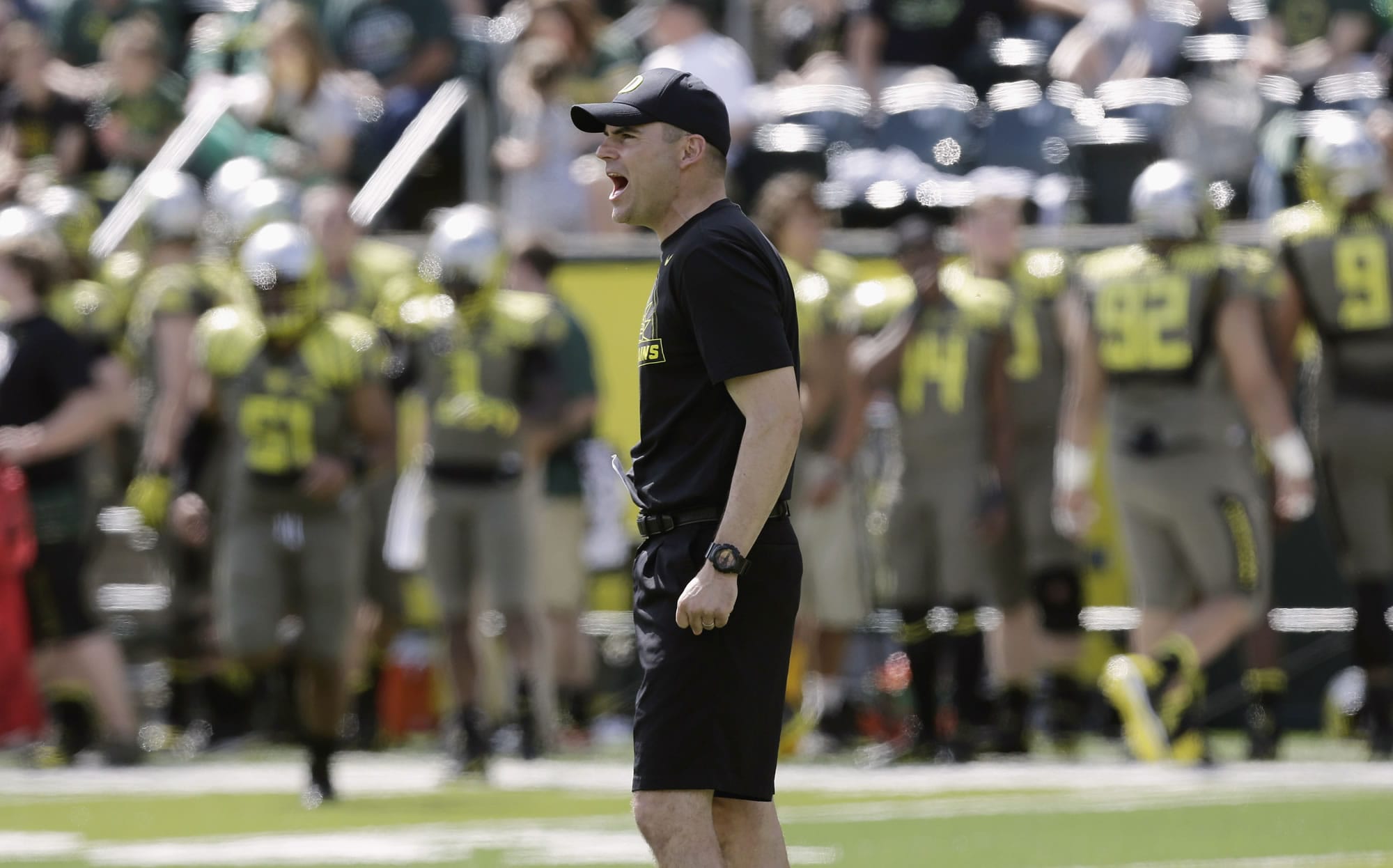 Oregon football coach Mark Helfrich shouts during their spring game in Eugene, Ore. Helfrich believes he is up to the task of keeping the Ducks flying high.