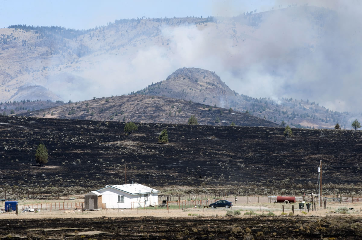 Smoke rises from wildfire near Warm Springs, Ore., on Monday.