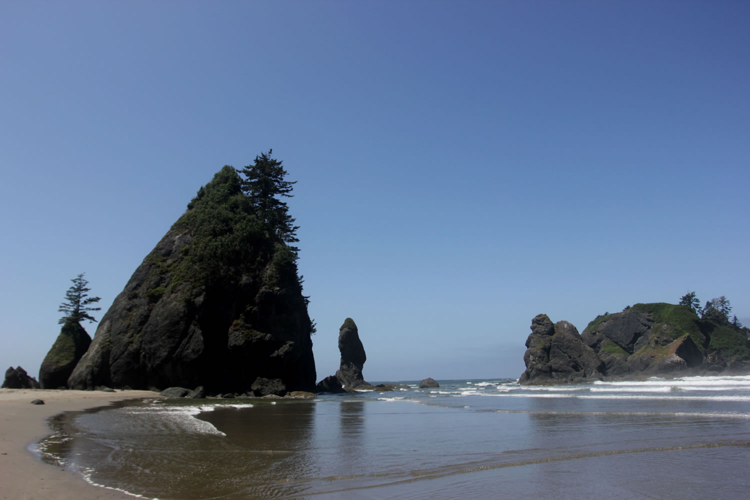 Sea rock formations known as the Point of Archers stand under the afternoon sun near Shi Shi Beach in Washington state's Olympic National Parks. Point of Archers offers hikers and campers great spots to explore sea creatures during low tide.
