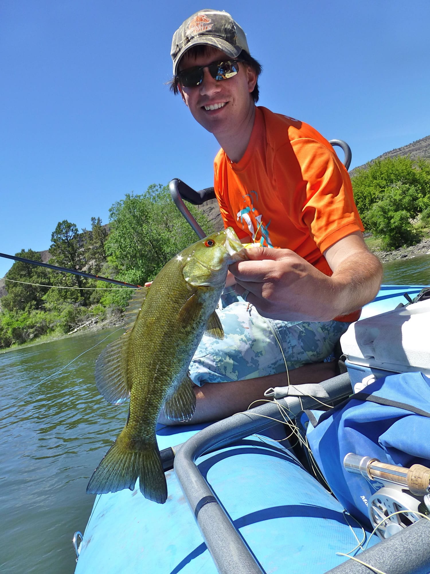 Darren Strong of Boise, Idaho, lands a smallmouth bass June 8 while floating on the John Day River near Fossil, Ore.