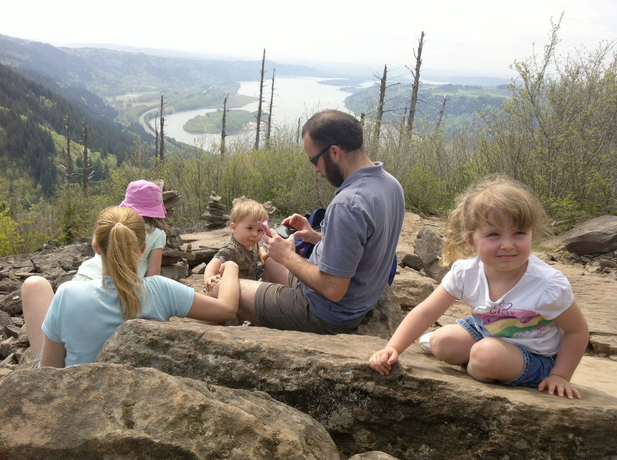 With the Columbia River visible in the distance, the Juhl family of Salem, Ore., parents Ben and Melissa, and Amelia, 5, Reagan, 18 months, and Brielle, 3, take a break near Angel's Rest near Bridal Veil, Ore.