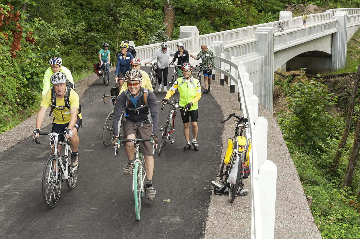 Bicyclists ride on the new McCord Creek Bridge, part of the Historic Columbia River Highway State Trail, near Cascade Locks, Ore. Cyclists will soon have a new recreation option after the missing link in the Historic Columbia River Highway State Trail opens. The section will be fully useable after Oct.