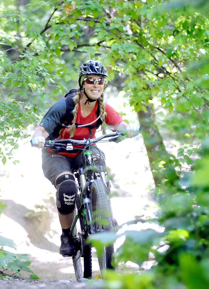 Sue Roussel, co-owner of Ashland Mountain Adventures, mountain bikes down Toothpick Trail this month outside of Ashland, Ore.
