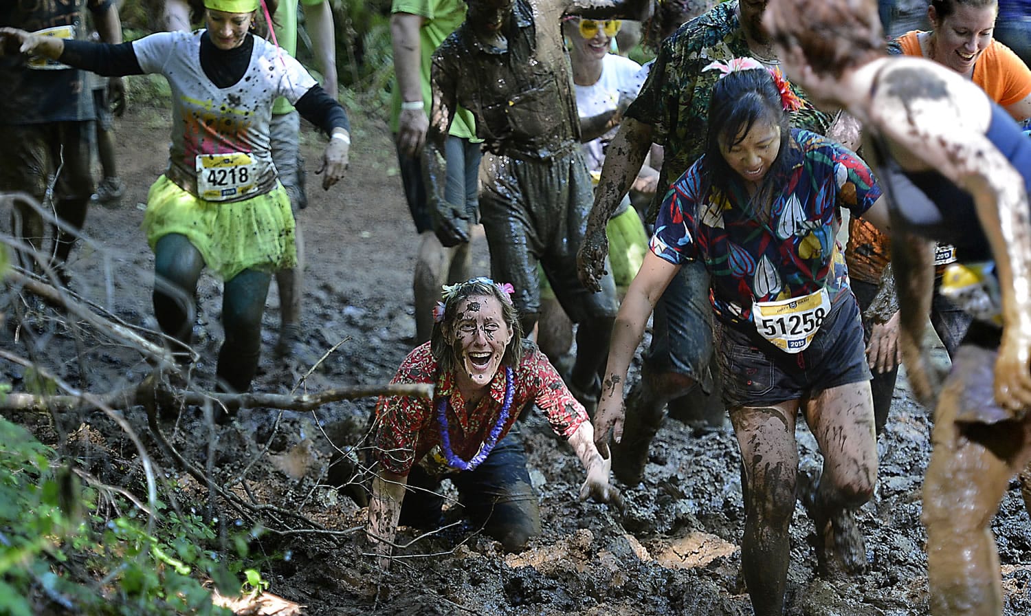 Participants get dirty during &quot;The Dirty Dash,&quot; a race where people wallow through a 5K mud course.