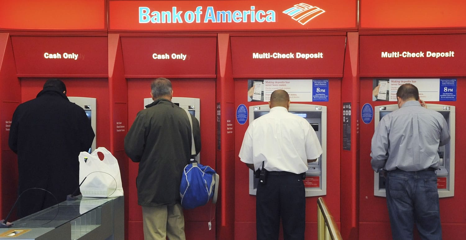 Customers use ATMs at a Bank of America branch office, in Boston.