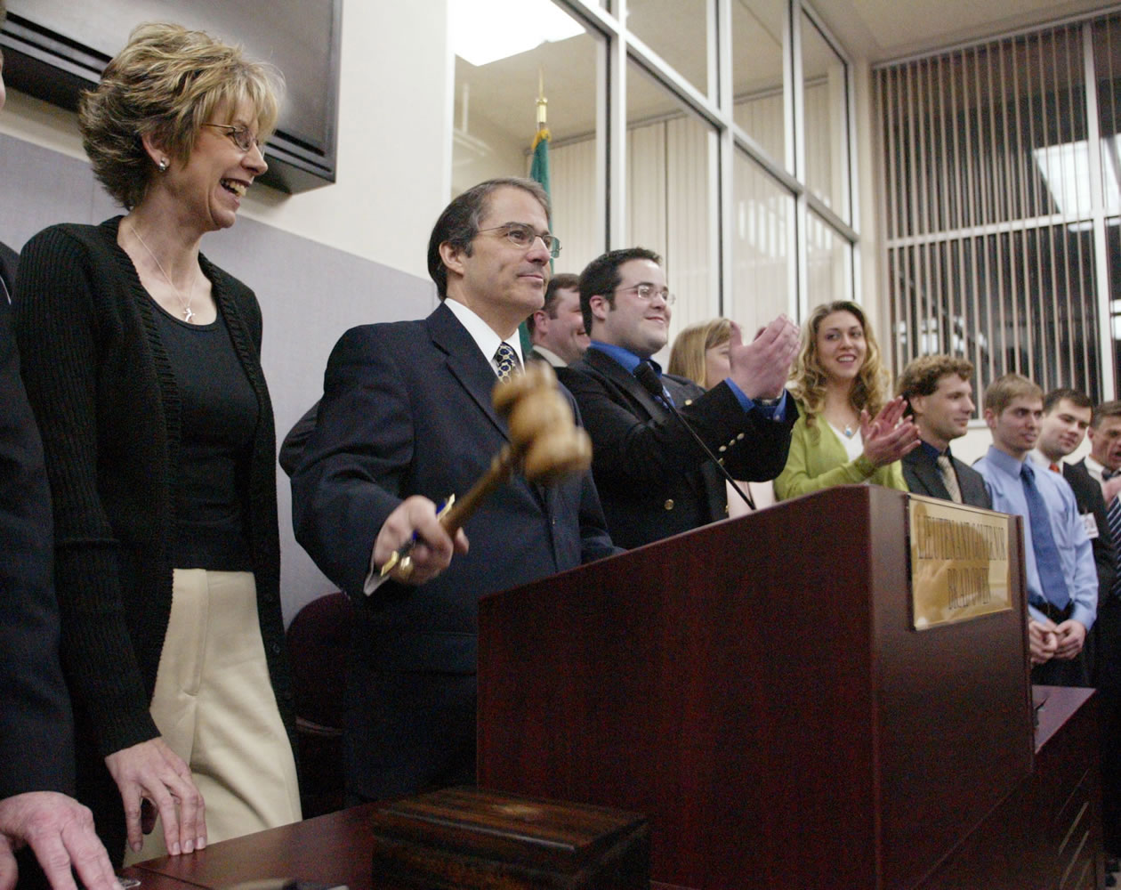In this 2004 file photo, Lt. Gov. Brad Owen with his wife, Linda, strikes the gavel in the Senate ending the session in Olympia.
