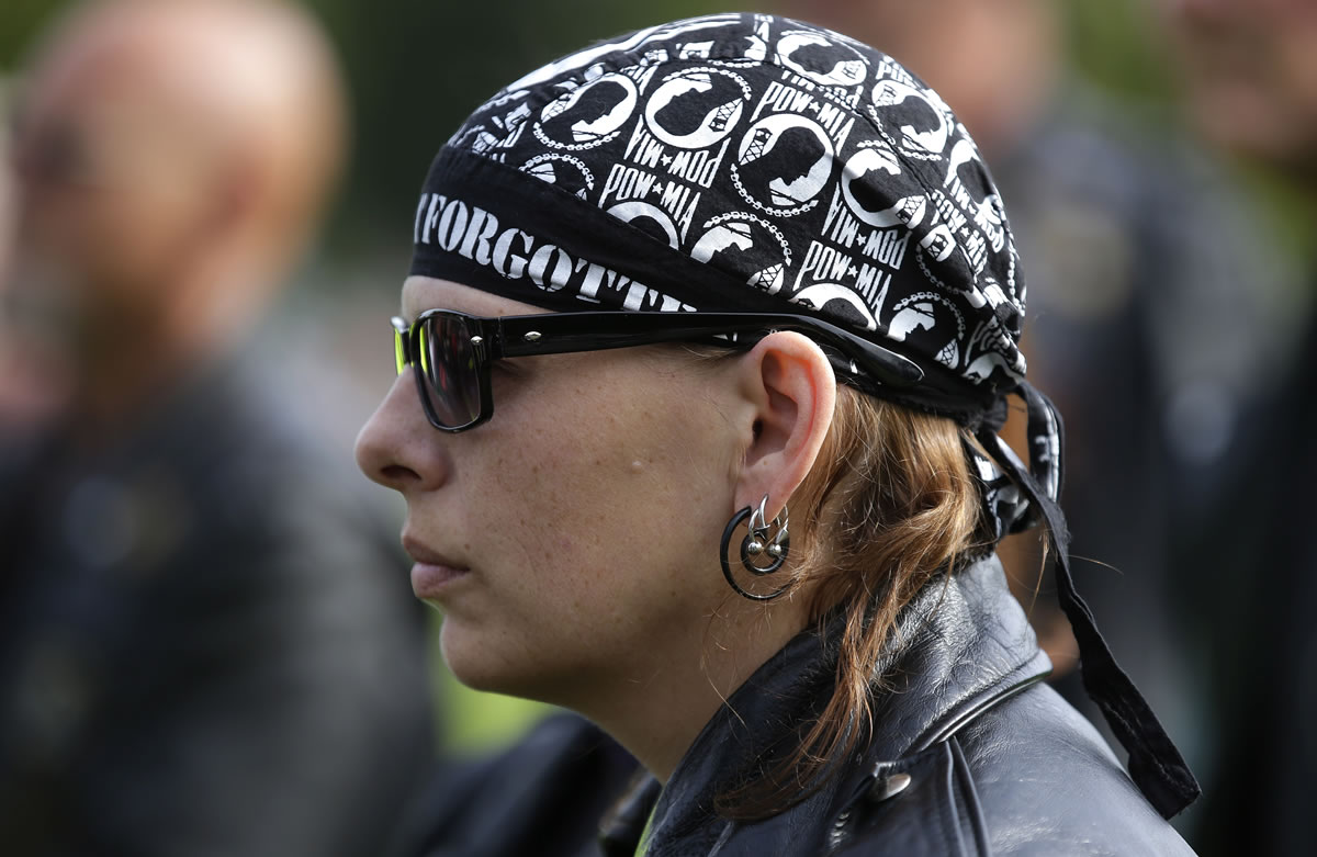 Charlette Johnson of the Patriot Guard Riders motorcycle club wears a POW/MIA bandanna at the ceremony, one of many held nationally.