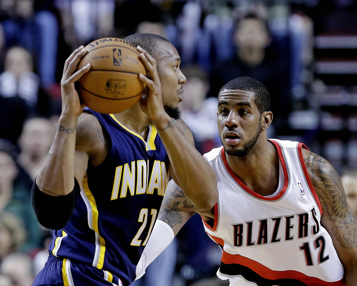 Portland Trail Blazers forward LaMarcus Aldridge, right, defends Indiana Pacers forward David West during the first quarter of an NBA basketball game in Portland, Ore., Wednesday, Jan. 23, 2013.