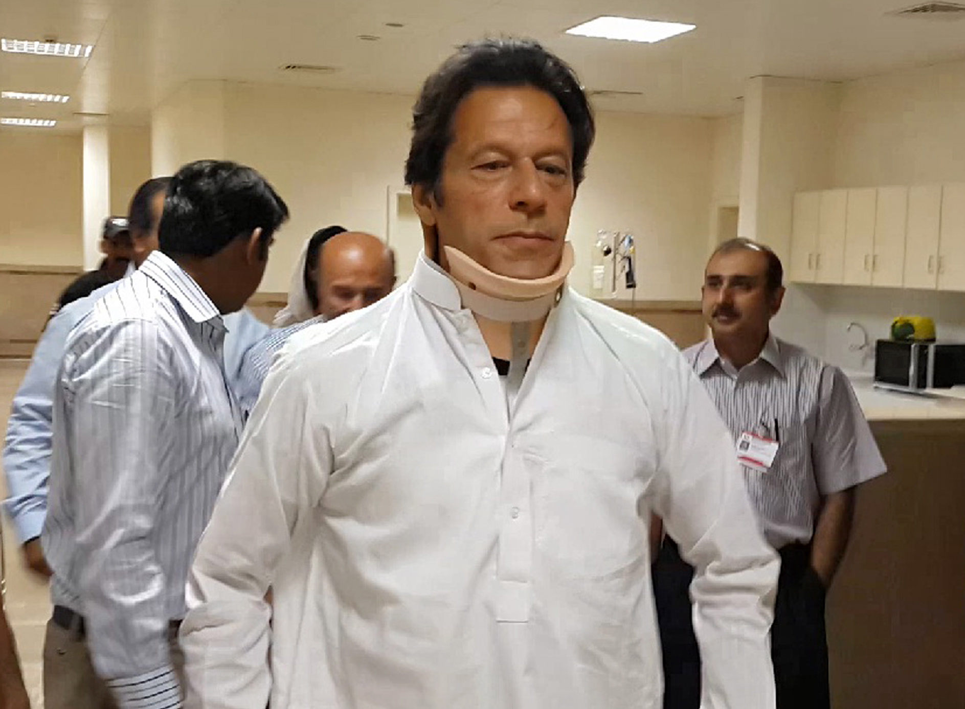Pakistan's cricketer turned politician Imran Khan, leader of Pakistan Tehreek-e-Insaf party, leaves the hospital in Lahore, Pakistan, on Wednesday.