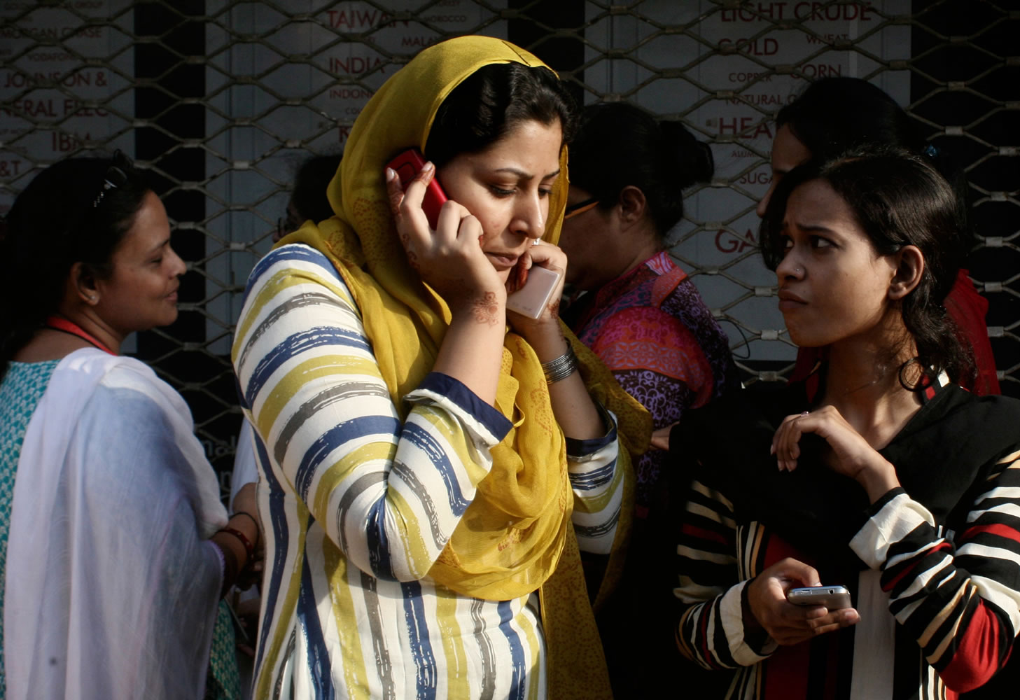 A Pakistani woman speaks on her mobile phone after rushing out of her apartment following a major earthquake that struck Baluchistan province in southwest Pakistan 430 miles from Karachi, Pakistan, on Tuesday.