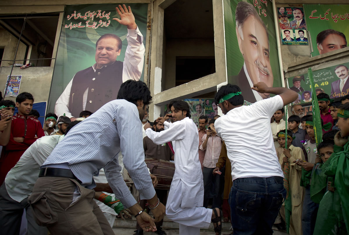 Supporters of Pakistan's former Prime Minister Nawaz Sharif celebrate the victory of their leader in Islamabad, Pakistan, on Sunday.