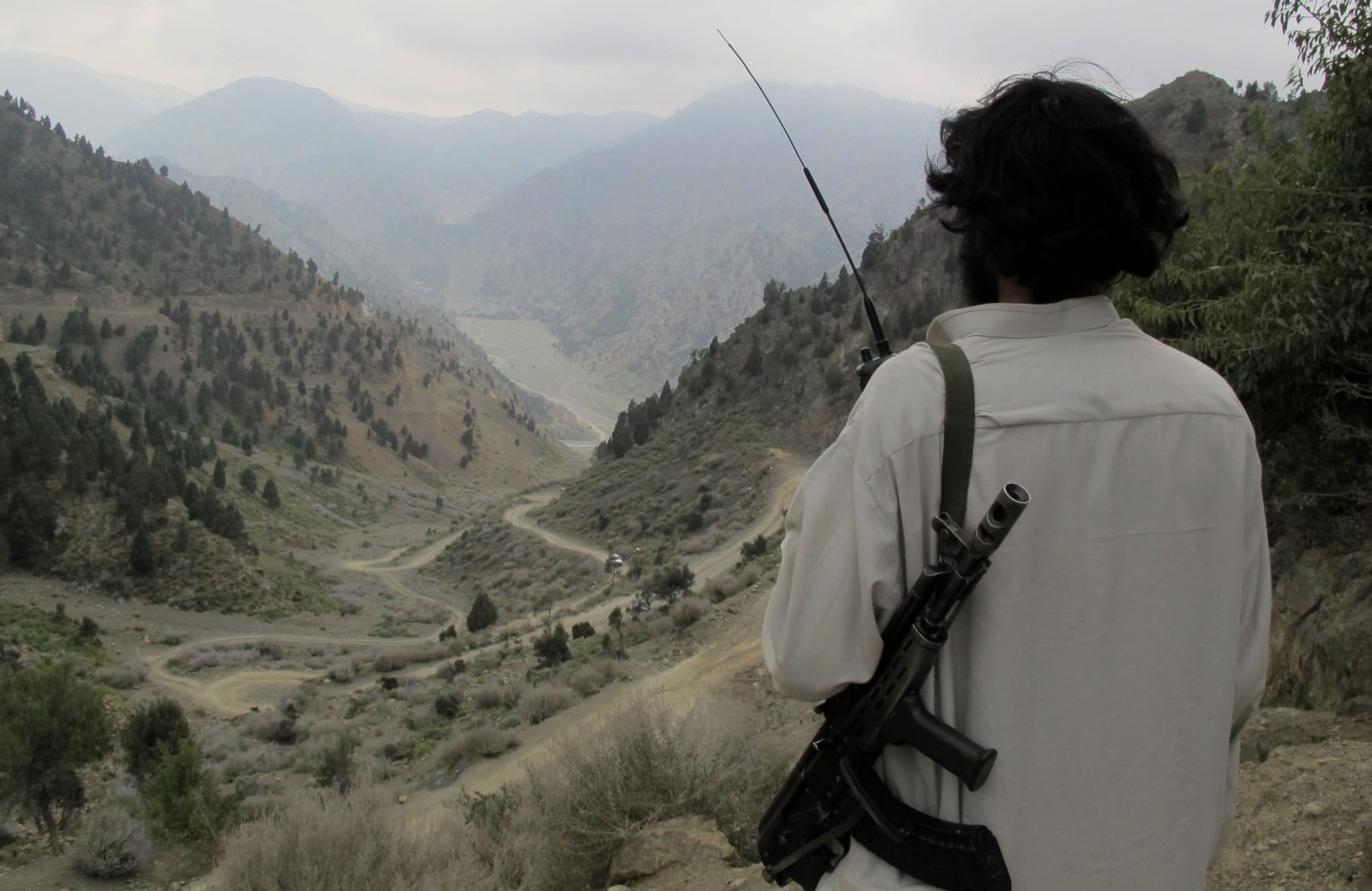 A Pakistani Taliban militant looks down at the main road of Shawal in the Pakistani tribal region of North Waziristan last month.