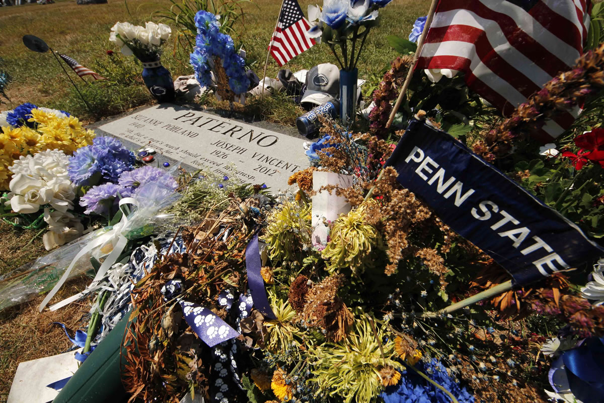 Items left by visitors surround the gravestone of former Penn State football coach Joe Paterno at the Spring Creek Presbyterian Cemetery in State College, Pa., Thursday, July 12, 2012. After an eight-month inquiry, Former FBI director Louis Freeh's firm produced a 267-page report that concluded that Paterno and other top Penn State officials hushed up child sex abuse allegation against Jerry Sandusky more than a decade ago for fear of bad publicity, allowing Sandusky to prey on other youngsters. (AP Photo/Gene J. Puskar) (AP Photo/Gene J.