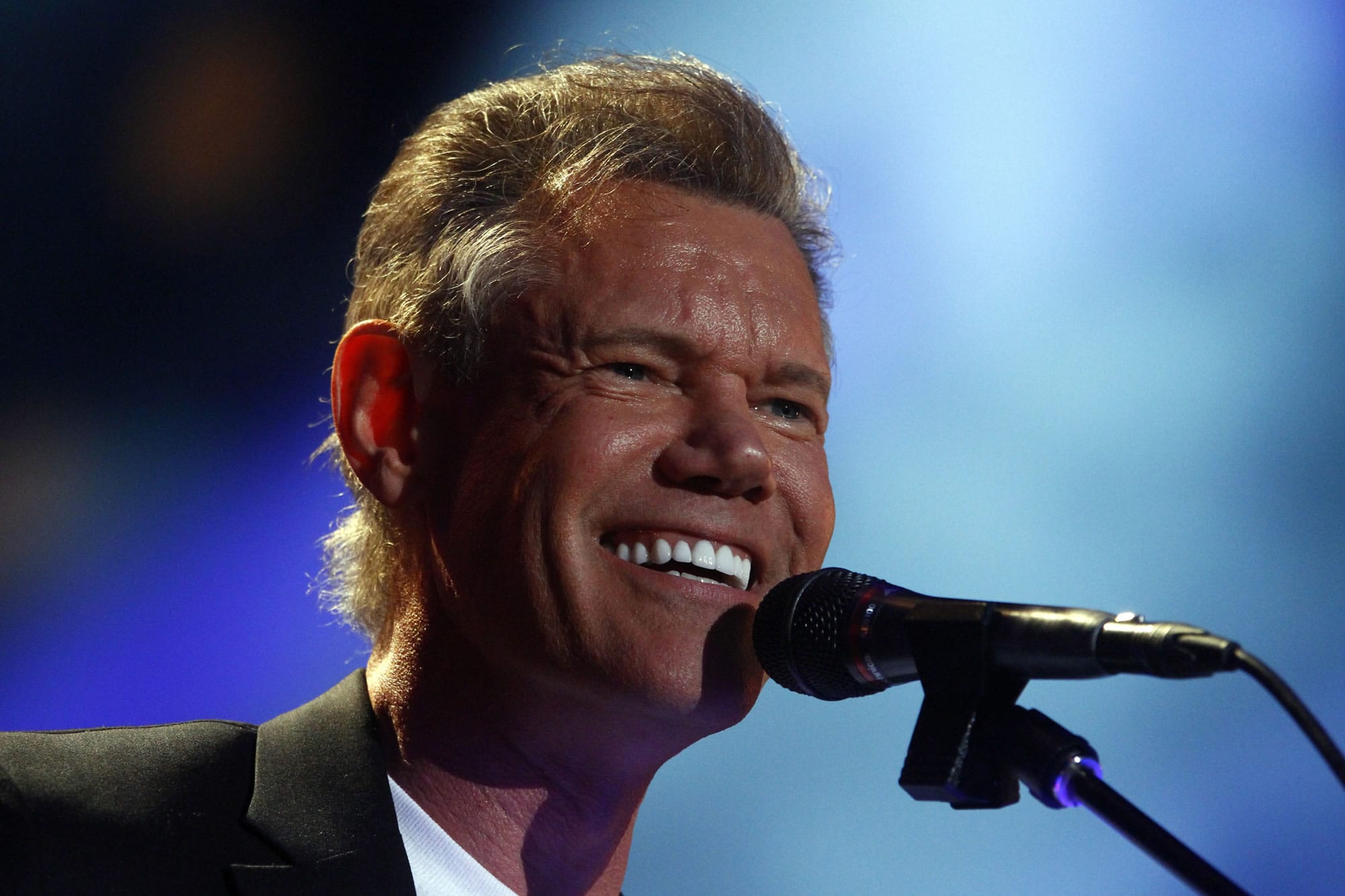Randy Travis performs June 7 in the 2013 CMA Music festival at the LP Field in Nashville, Tenn. Publicist Kirt Webster on Wednesday night, July 10, 2013 said that the 54-year-old Travis is in surgery after suffering a stroke while he was being treated for congestive heart failure because of a viral illness.