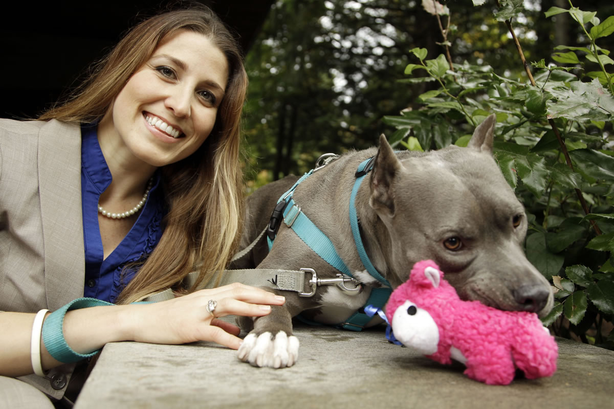 Lawyer Mitzi Bolanos poses with her pit bull, Bubba, at Lewis &amp; Clark Law School in Portland.