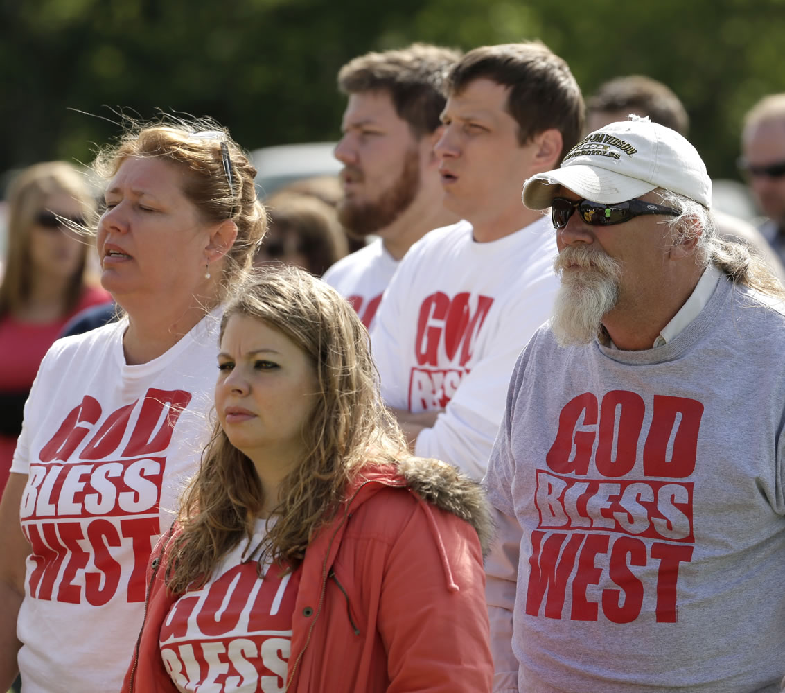 Churchgoers sing during a service for the First Baptist Church held in a field Sunday in West, Texas.
