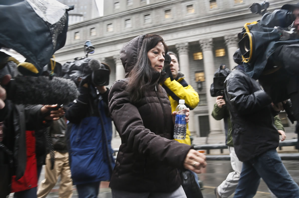 Elizabeth Valle is surrounded by news reporters as she leaves court on Tuesday in New York. A federal jury convicted her son, New York City police officer Gilberto Valle, of charges he plotted to kidnap and cook women to dine on their &quot;girl meat.&quot; Valle, 28, faces up to life in prison when he is sentenced on June 19.