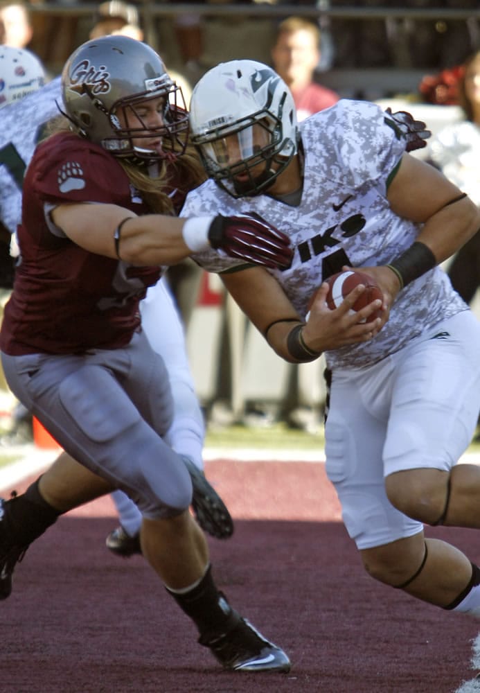 Montana defensive end Zack Wagenmann, left, grabs Portland State quarterback Kieran McDonagh (4) in the end zone during the first quarter Saturday.
