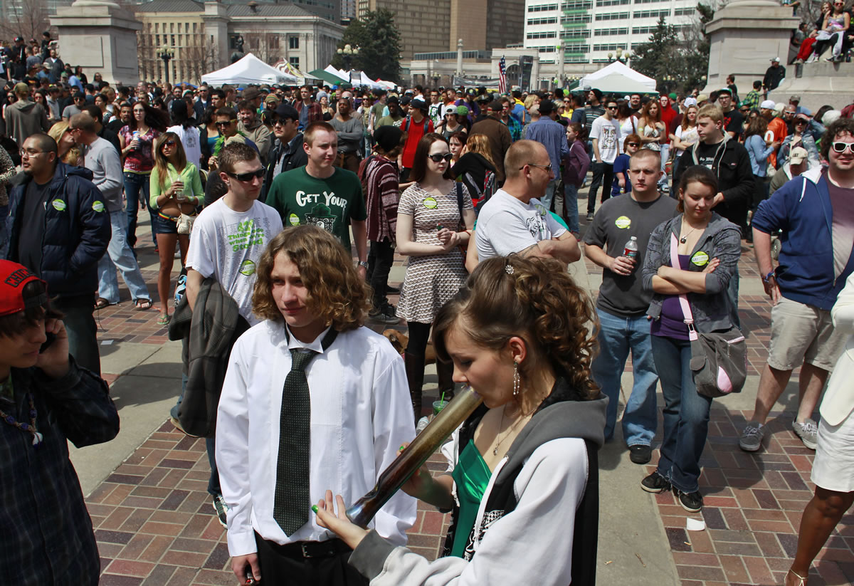 Youths smoke marijuana at the Denver 4/20 pro-marijuana rally at Civic Center Park in Denver on Saturday.
