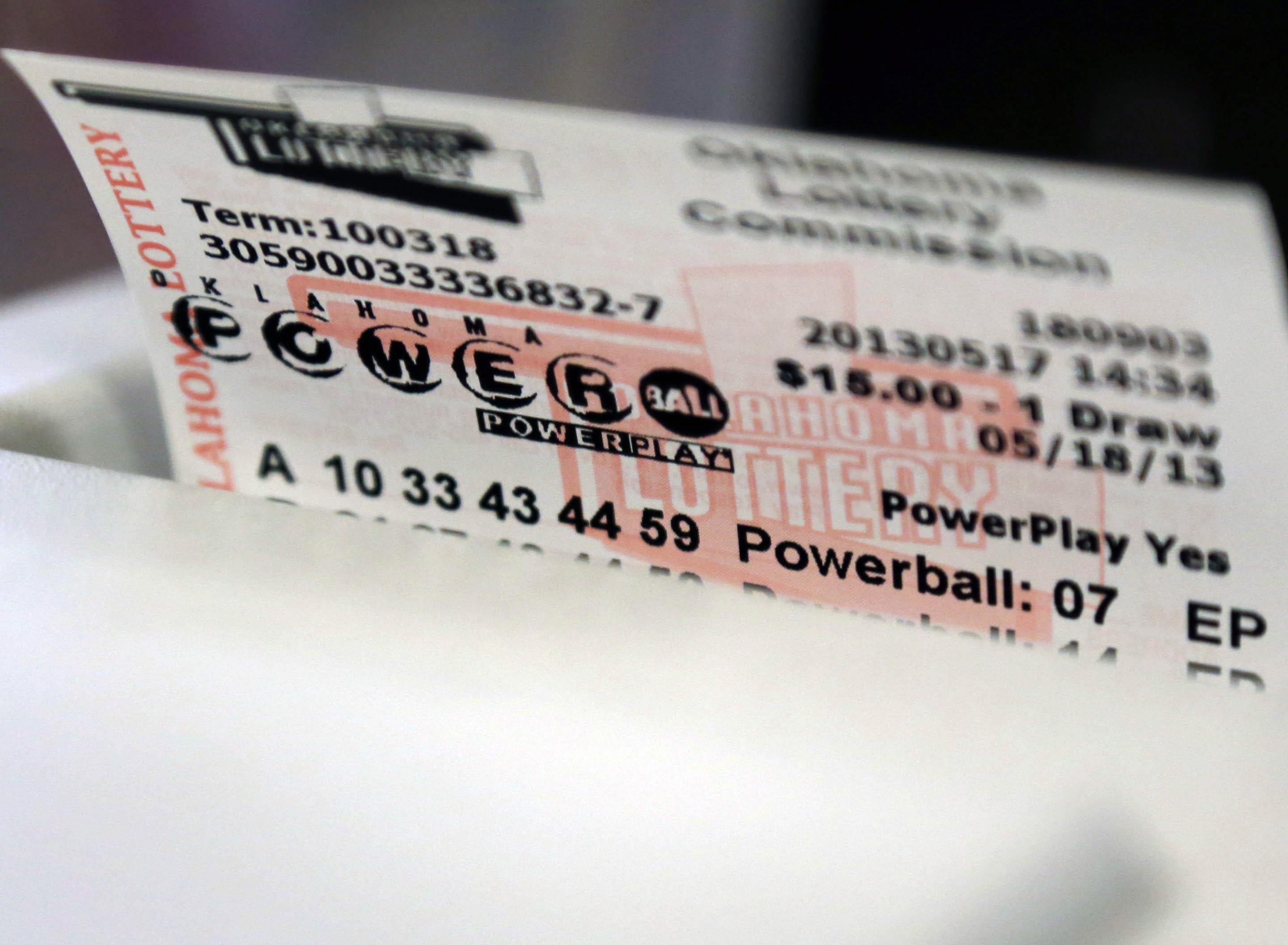 A Powerball Lottery ticket is dispensed from a machine in Oklahoma City, Friday, May 17, 2013.